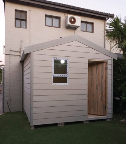 Spacious wooden Wendy house with a veranda